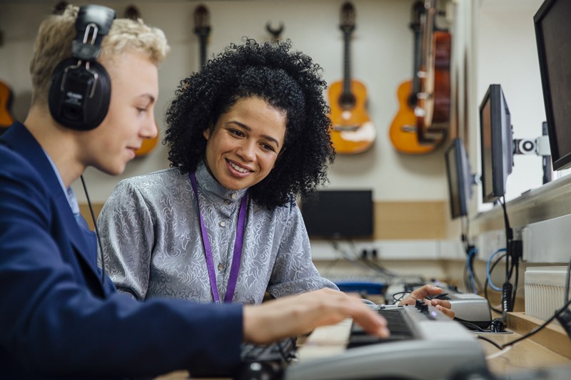 Therapist and Teen Boy Playing Piano